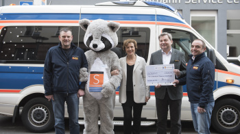 Guido Jost, Vorsitzender ASB-Landesverband Saarland, Saarbahn-Chef Peter Edlinger, Oberbürgermeisterin Charlotte Britz mit Saarbahn-Maskottchen Babu sowie Jürgen Müller, Projektleitung Wünschewagen bei der Übergabe des Schecks (v.r.) / Bild Saarbahn Wünschewagen